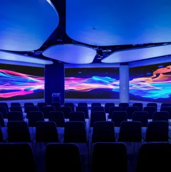 IQ Business Center in Kyiv - conference hall with rows of chairs and wide digital screens