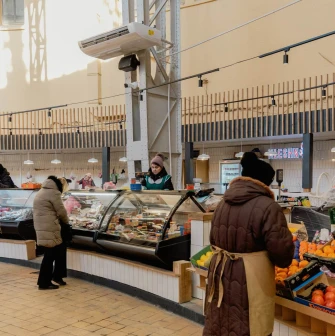Visitors browsing fresh produce stalls at Bessarabskyi Market in Kyiv