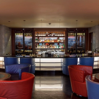 B-hush - a modern bar with numerous drinks and warm lighting