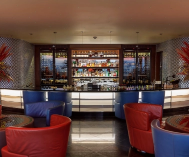 B-hush - a modern bar with numerous drinks and warm lighting