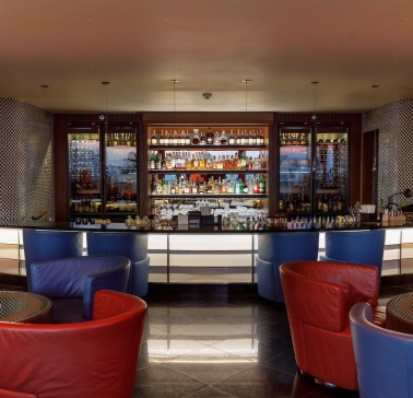 B-hush - a modern bar with numerous drinks and warm lighting