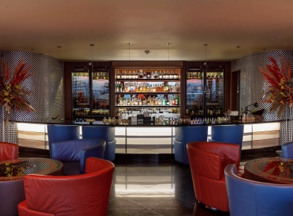 B-hush - a modern bar with numerous drinks and warm lighting