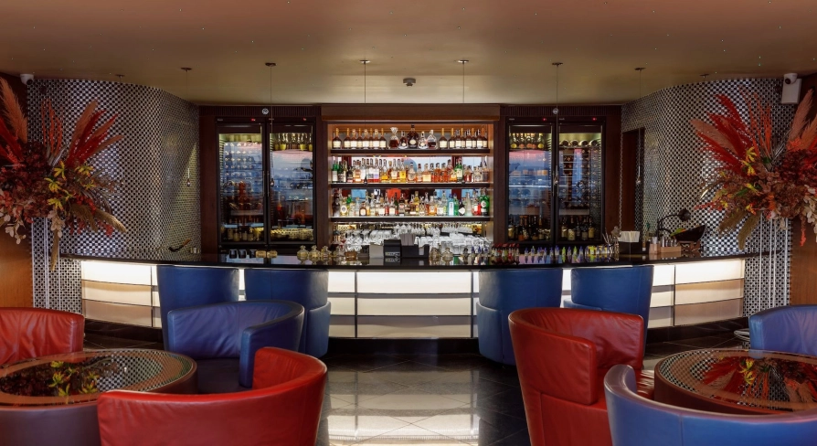 B-hush - a modern bar with numerous drinks and warm lighting