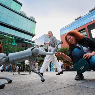 UNIT.City - a Boston Dynamics 'Spot' robot dog walking on a paved walkway
