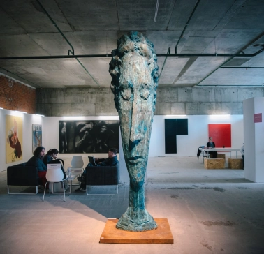 Large head sculpture in the M17 exhibition space in Kyiv