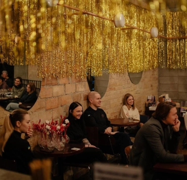 Restaurant Zigzag - interior with tinsel decorations a brick wall and seated guests