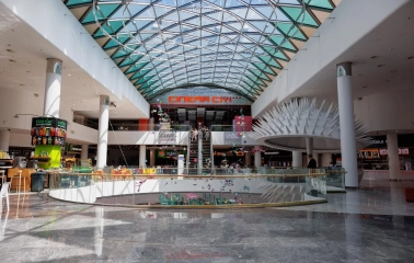 Ocean Plaza in Kyiv - grand central atrium under a curved glass dome featuring escalators leading to the cinema and a futuristic white spiky structure