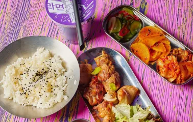 Street Kim - korean chicken rice set with side dishes on colorful table