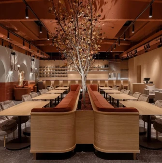 Zmist - stylish dining area with dark decor and decorated tree