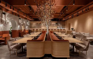 Zmist - stylish dining area with dark decor and decorated tree