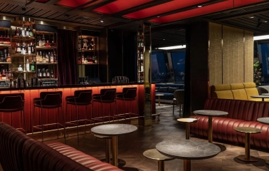 11 Mirrors Restaurant & Bar - sleek modern bar counter with high stools and bottle display