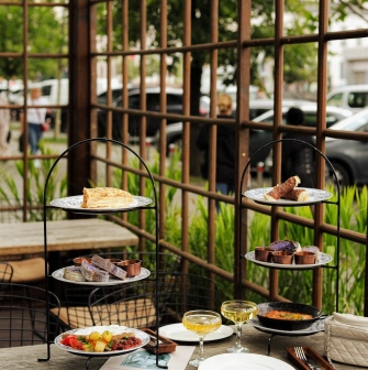 In Italy - a terrace made of wooden arches, a pile of delicacies on the table
