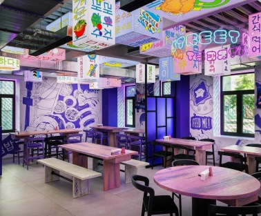 Street Kim - narrow dining space featuring small tables and wooden benches along the wall