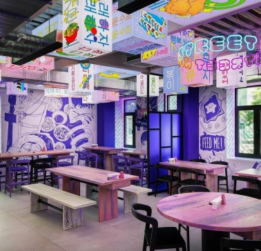 Street Kim - narrow dining space featuring small tables and wooden benches along the wall