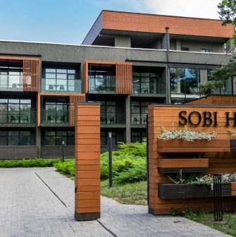Facade of the modern Sobi Club hotel building in the forest