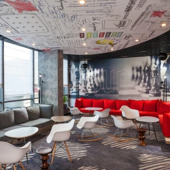Ibis Railway Station in Kyiv - lounge with red sofas and ceiling graffiti