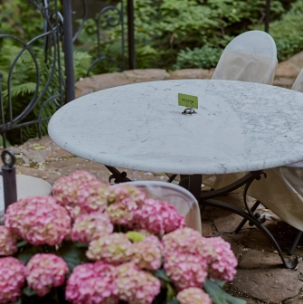 Terasa - marble table with reserved sign on garden terrace