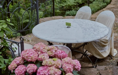 Terasa - marble table with reserved sign on garden terrace