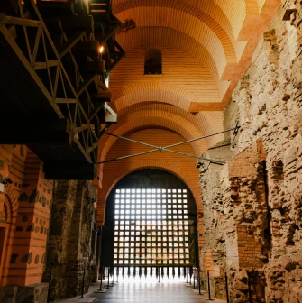 Golden Gate in Kyiv - interior view of the ancient stone passage with brick arches and the wooden portcullis gate