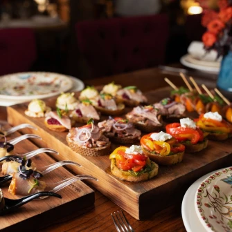 Restaurant Khutorets na Dnipri - assorted canapés and appetizers on wooden serving boards
