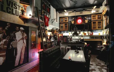 Vintage seating room at Buena Vista Social Club with brick walls