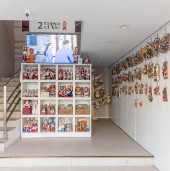 Interior view with souvenir dolls and stairs to the second floor of the Folkmart store in Kyiv