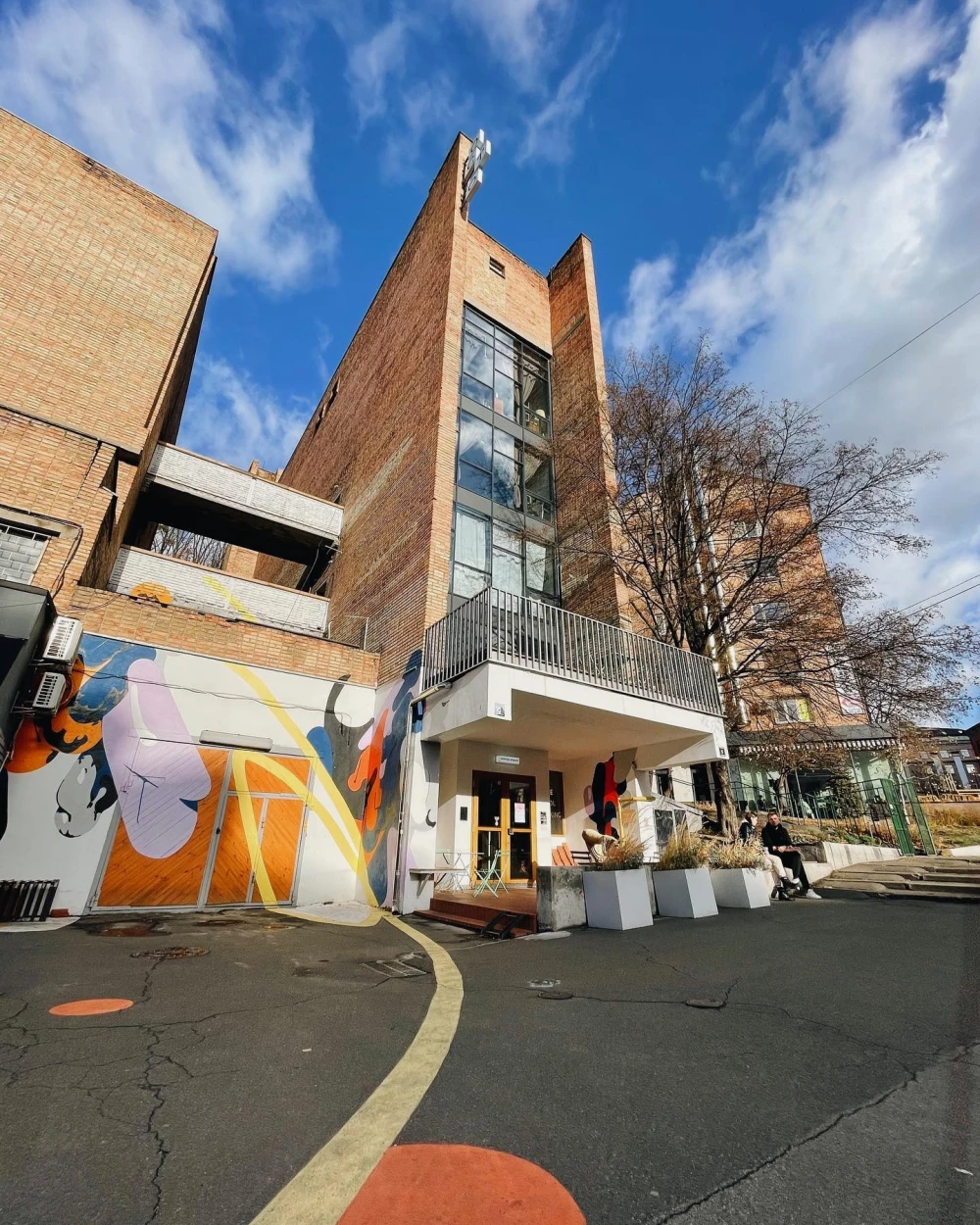 Octo Tower - brick building facade with colorful mural and entrance