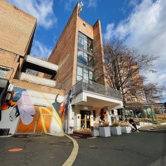 Octo Tower - brick building facade with colorful mural and entrance