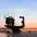 Monument to the Founders of Kyiv at sunset - dramatic silhouette over the Dnipro River and city skyline