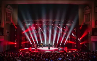 October Palace in Kyiv - concert stage illuminated by red spotlights beams