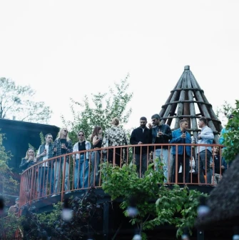 Kureni - guests on upper terrace with wooden tower structure