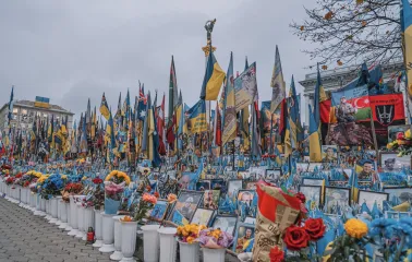 Independence Square in Kyiv - rows of portraits of fallen soldiers, flowers, and flags