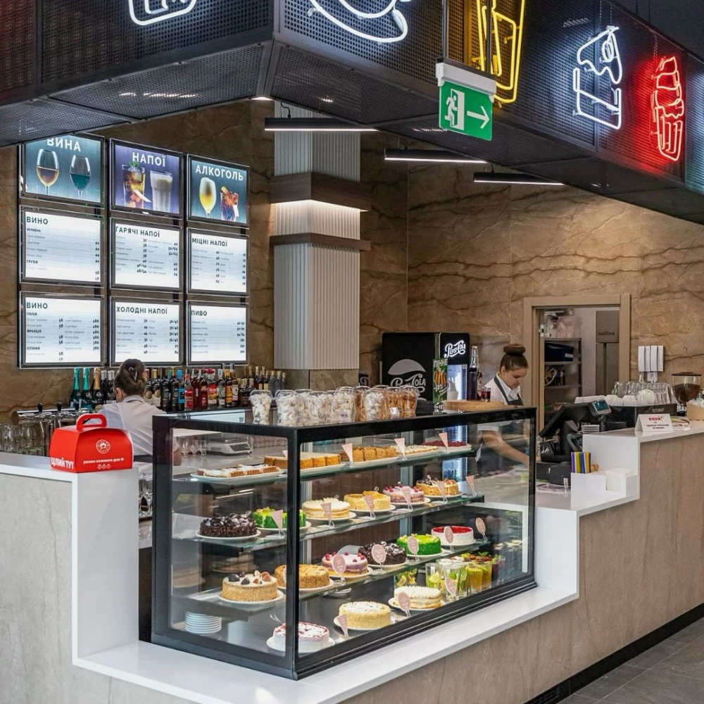Restaurant Puzata Hata - dessert bar with a glass display case full of cakes and pastries