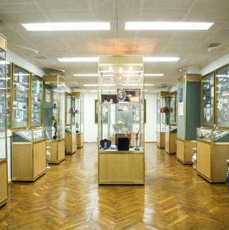 Palats Sportu in Kyiv - museum room lined with glass cases displaying golden sports trophies and memorabilia