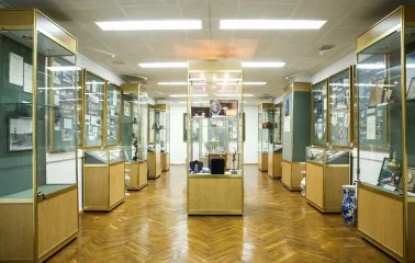 Palats Sportu in Kyiv - museum room lined with glass cases displaying golden sports trophies and memorabilia
