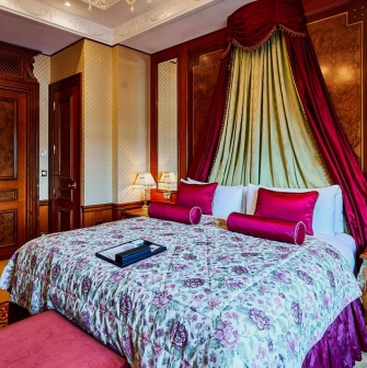 Luxurious room at the Fairmont Grand Hotel in Kyiv with red decoration and classic interior