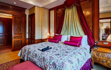 Luxurious room at the Fairmont Grand Hotel in Kyiv with red decoration and classic interior