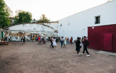 Lavra Gallery in Kyiv - a crowd of people spending time in a spacious white brick courtyard during an art event
