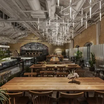 Kyiv Food Market interior with wooden tables, food courts around the perimeter and high ceiling