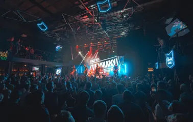 Atlas in Kyiv - vibrant concert atmosphere with blue neon geometric lights on the ceiling and a band on stage