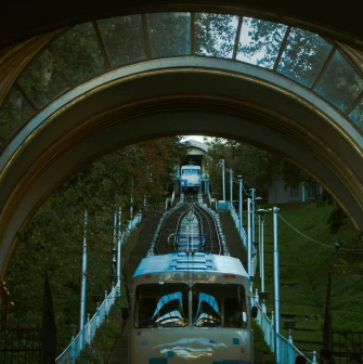 Kyiv Funicular - view through the station arch of a blue carriage ascending