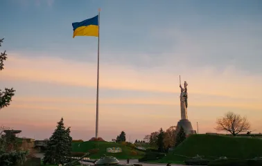 Motherland - sunlit steel statue raising a sword and shield to the sky