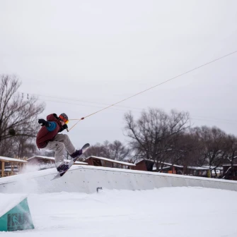 X-Park in Kyiv - snowboarder performing a high jump trick over a ramp