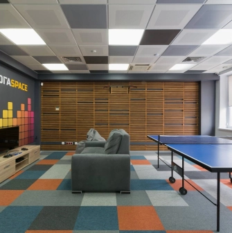 Peremoga Space - room with a console, a sofa and table tennis