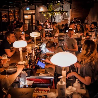 Pab Kedy - busy bar counter with bartenders serving drinks to many guests