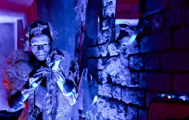 Performer in a white mask with crystals at Alchemist Bar