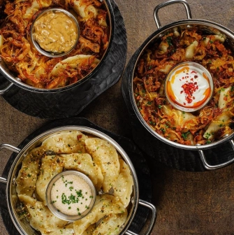 Restaurant Chary - three bowls of vareniky and dumplings topped with fried onion and sour cream