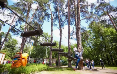 Seiklar Park in Kyiv - large orange squirrel sculpture welcoming visitors near the start of the rope trails surrounded by green foliage