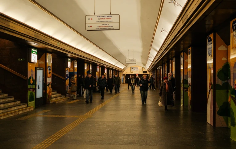 Hall of the Teatralna metro station in Kyiv with passengers and navigation signs