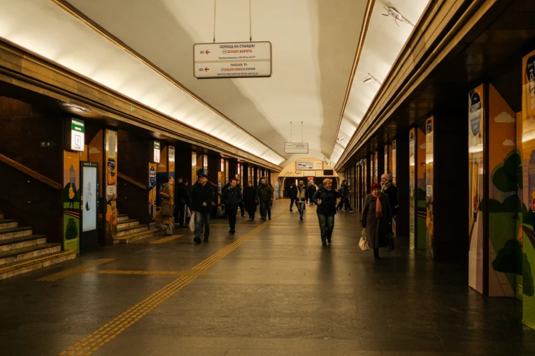 Hall of the Teatralna metro station in Kyiv with passengers and navigation signs